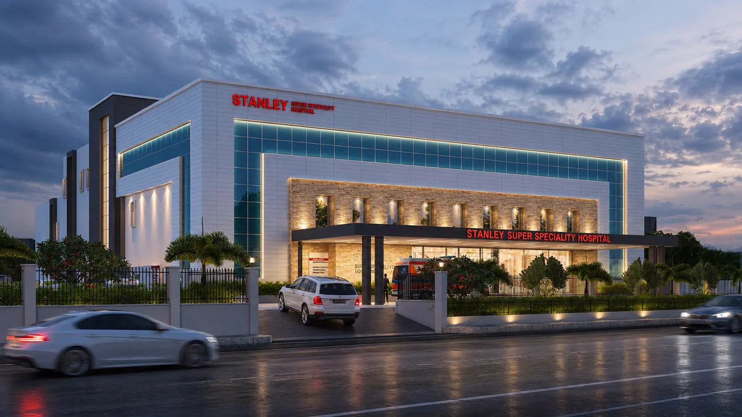 Stanley Super Speciality Hospital, entrance canopy at dusk.